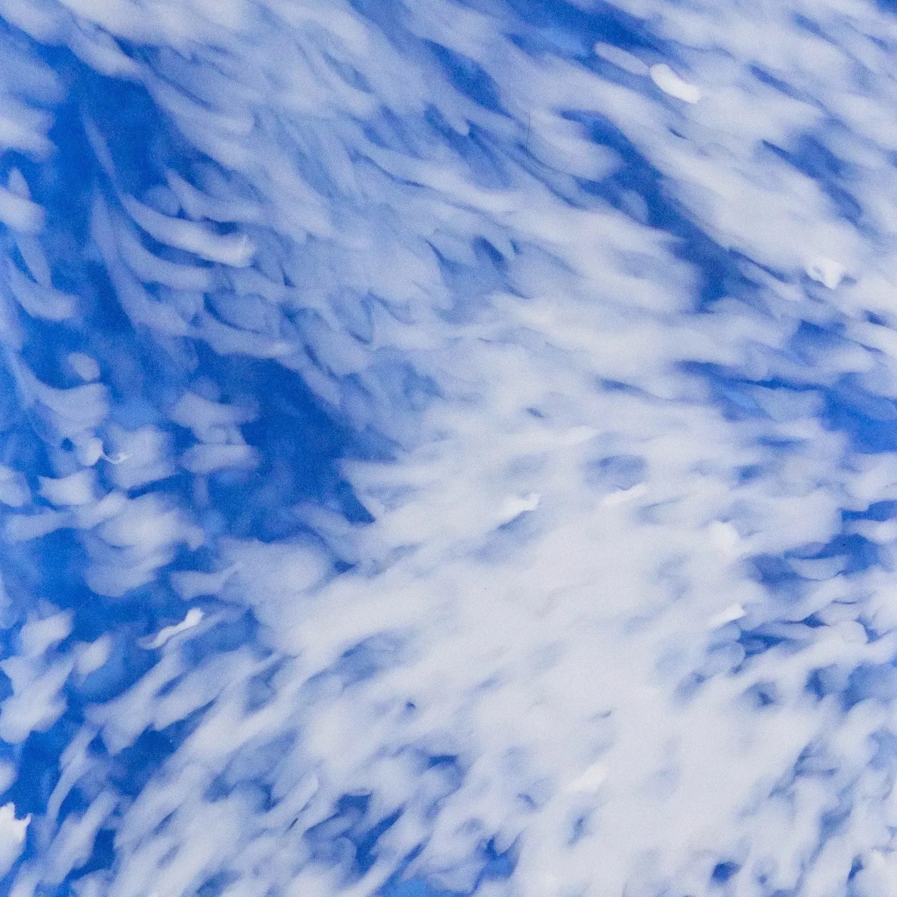 White speckles on a blue recycled plastic panel