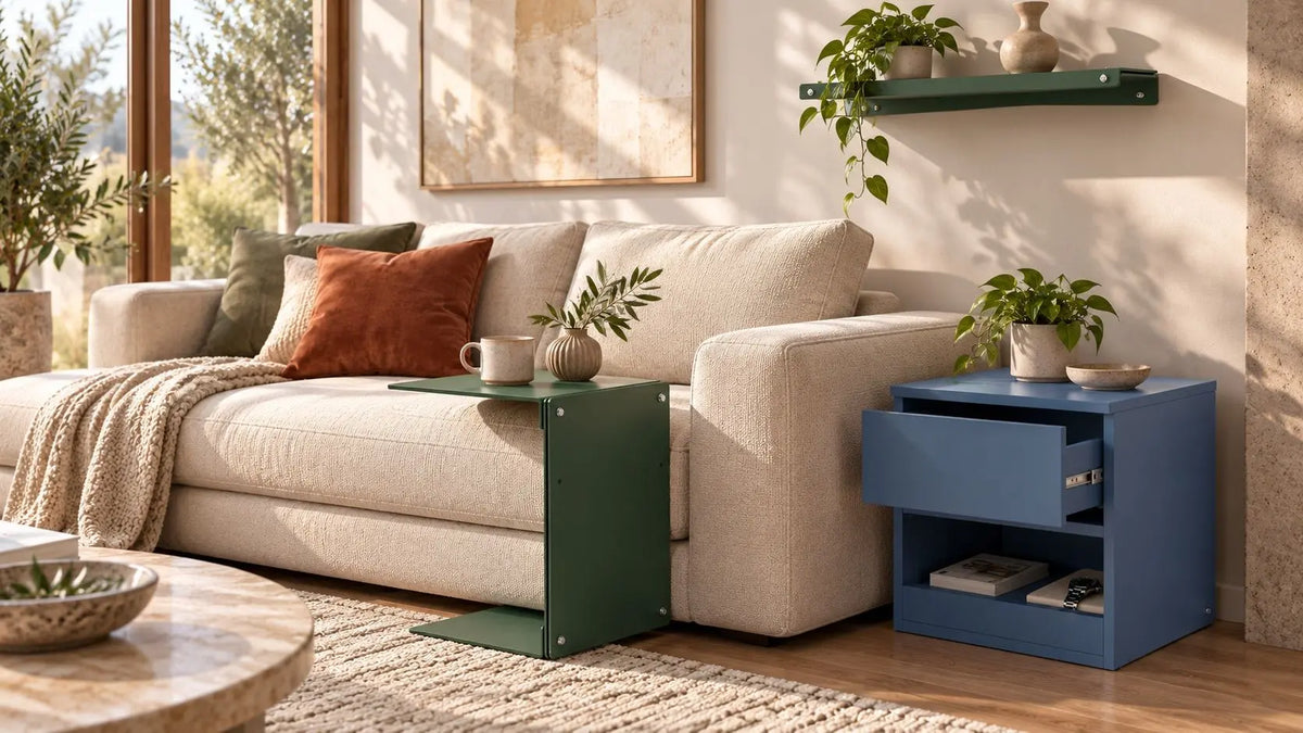 A modern living room scene featuring a cream-colored sofa with accent pillows, a dark green side table, and a blue side table with an open drawer, styled with plants and home decor. Aluminum furniture and hidden compartment furnitute.